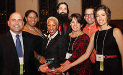 George Tsanis and Pat Braus congratulate representatives of the Youth Apprenticeship Program of Rochester General Hospital